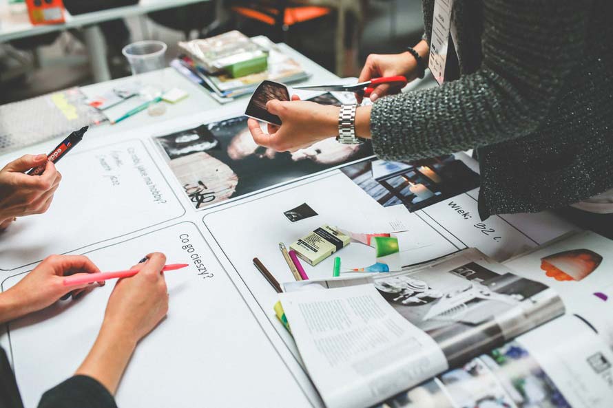 Hands working on UX design of a mobile app